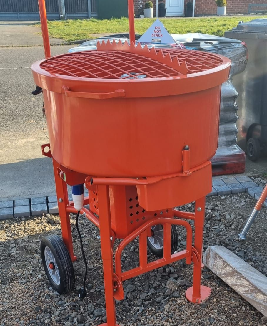 Orange cement mixer on a sunny day; wheels on the legs