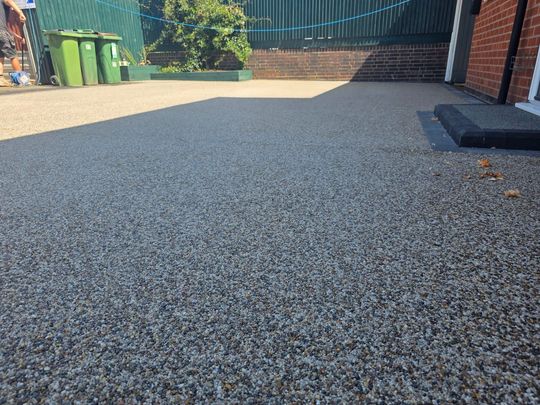 completed resin driveway outside with job finished and tidy area.