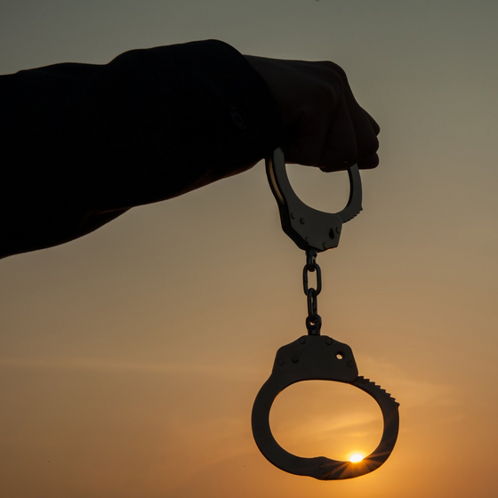 Bail Bonds Near Me — Man Holding Handcuffs in Overland Park, KS