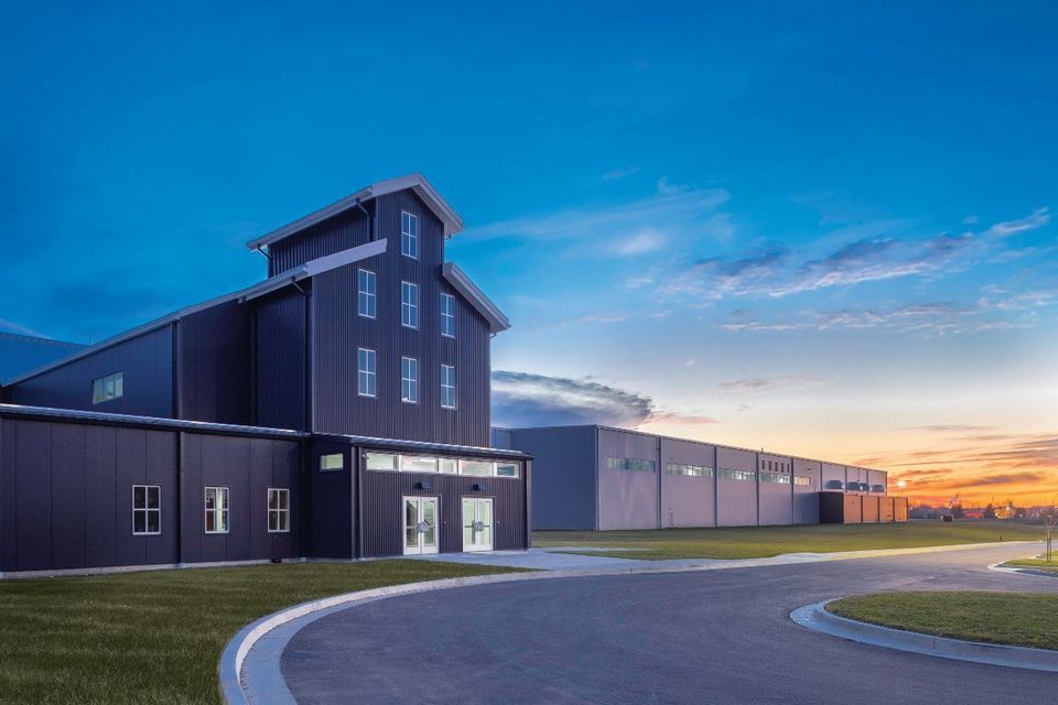 More Than A Bakery headquarters against a sunset sky.