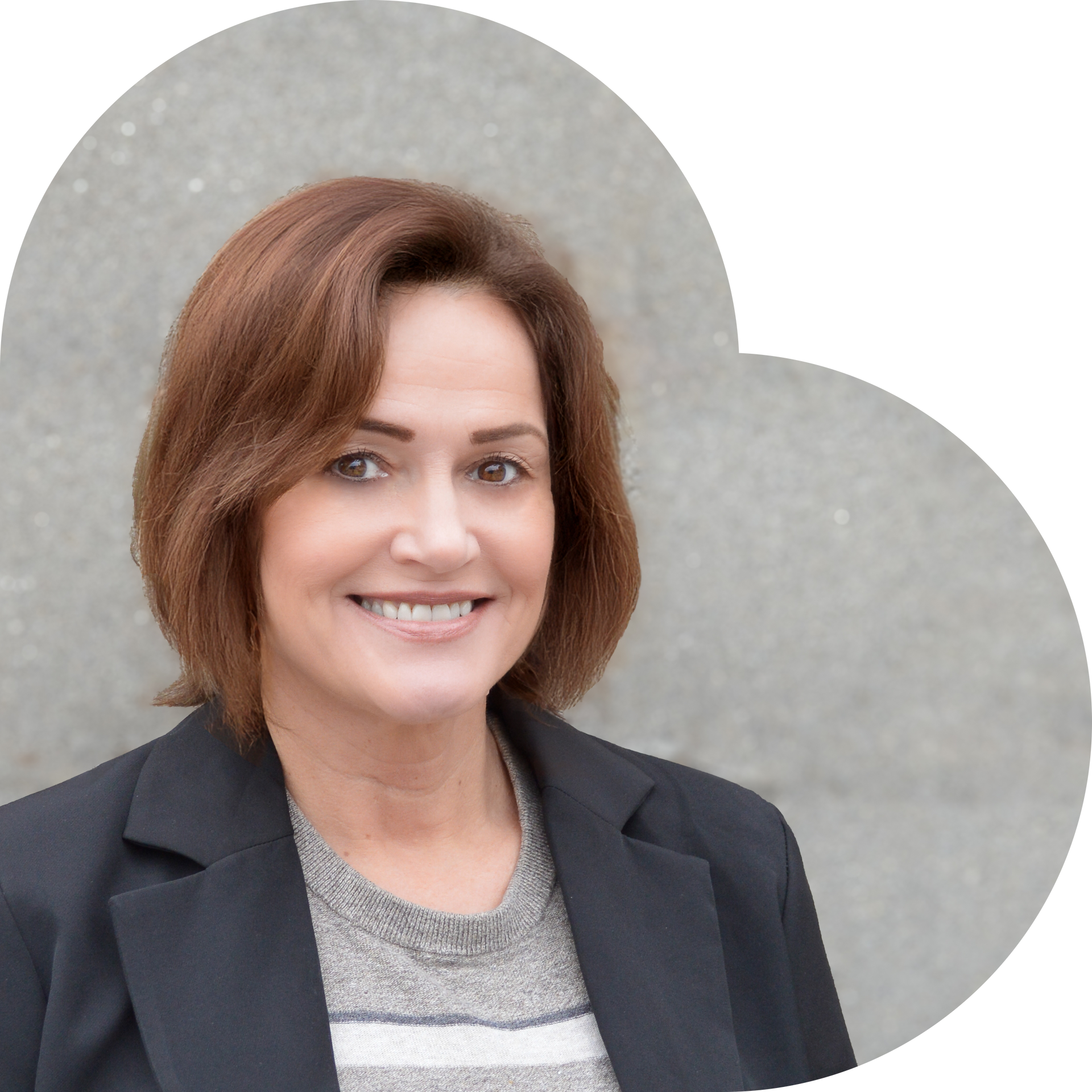 Woman in a black blazer smiles, set against a grey heart-shaped background.