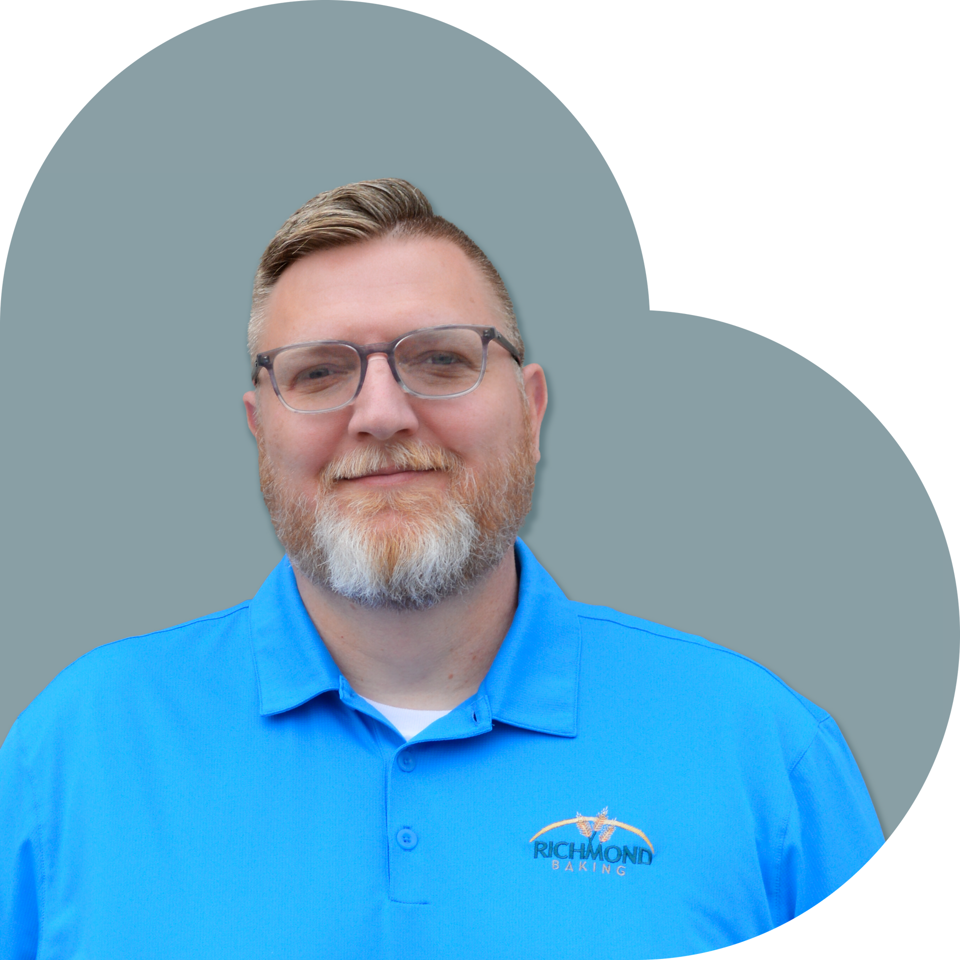 Man in a blue polo smiles, set against a blue heart-shaped background.