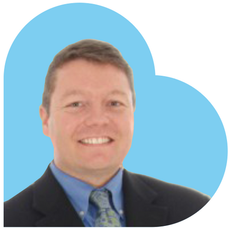 Man in a suit smiling, set against a blue heart-shaped background.