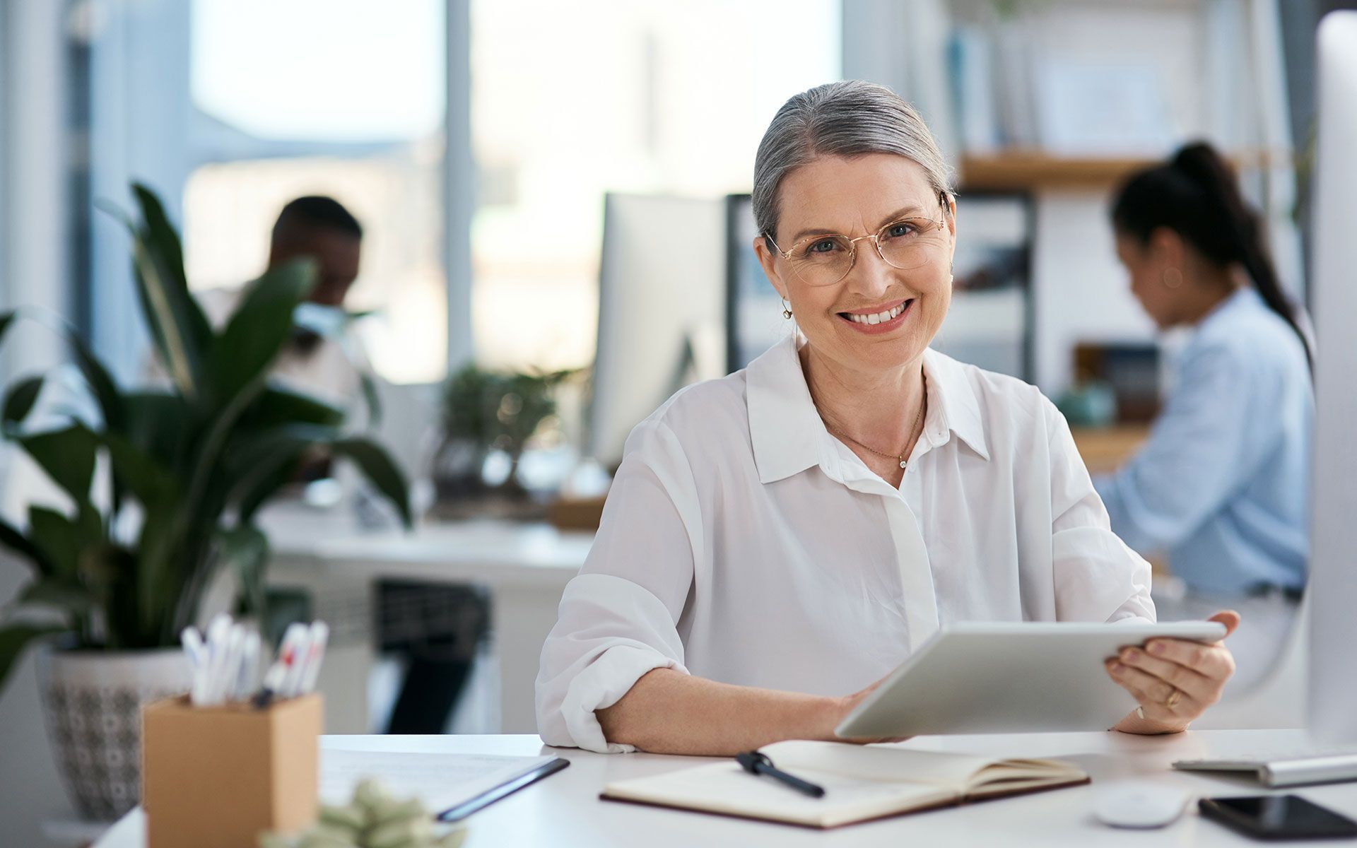 A man and a woman are sitting at a table looking at a piece of paper.