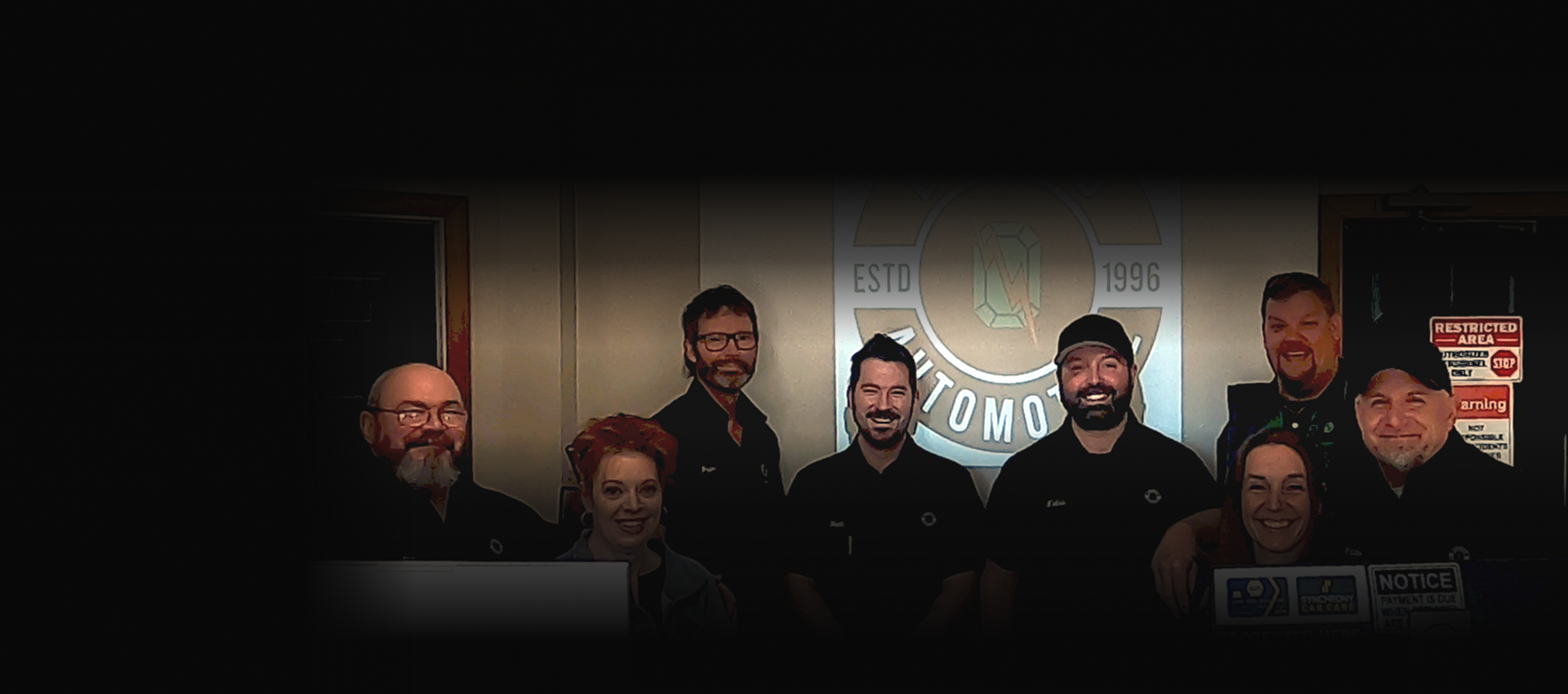 A man is working on a car engine with a wrench. | Emerald Automotive