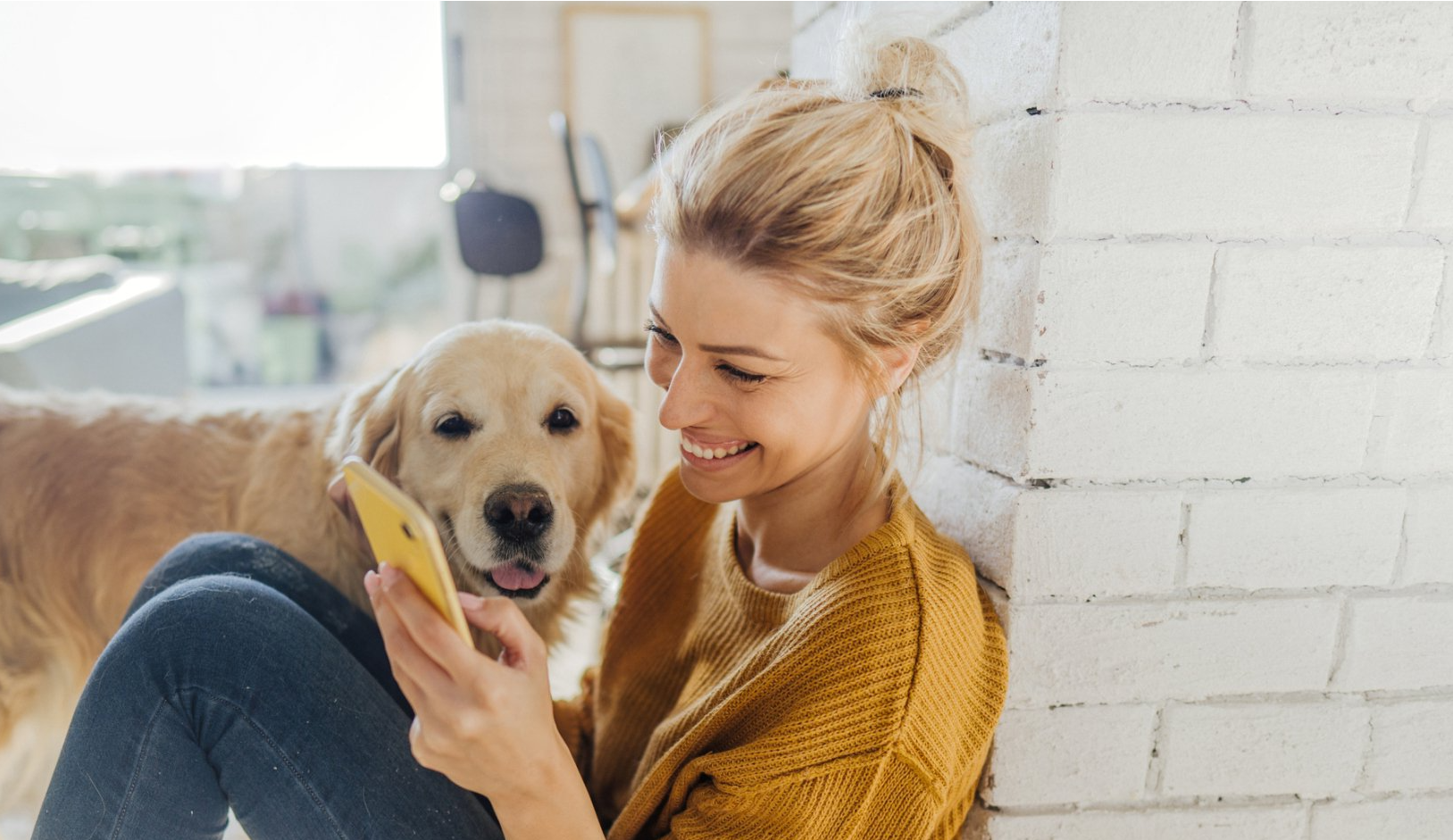 woman and dog on phone