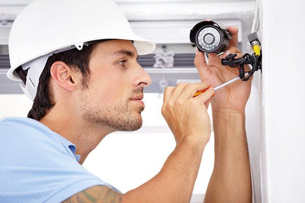 man repairing cctv camera