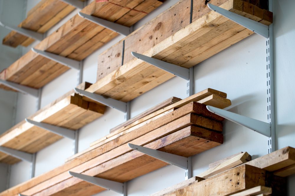Wooden planks stored on wall-mounted shelves — DGW Wholesale Timber & Hardware in Beresfield, NSW