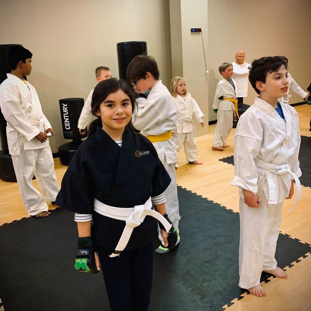 Two people practicing Brazilian Jiu-Jitsu on a mat. One is on top, applying a hold.