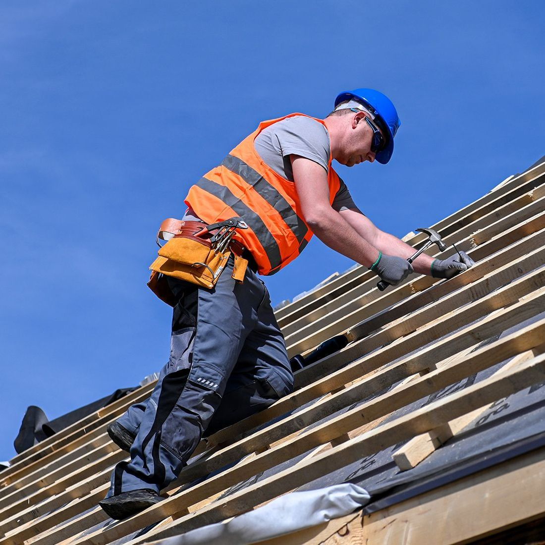 A man is working on the roof of a building.