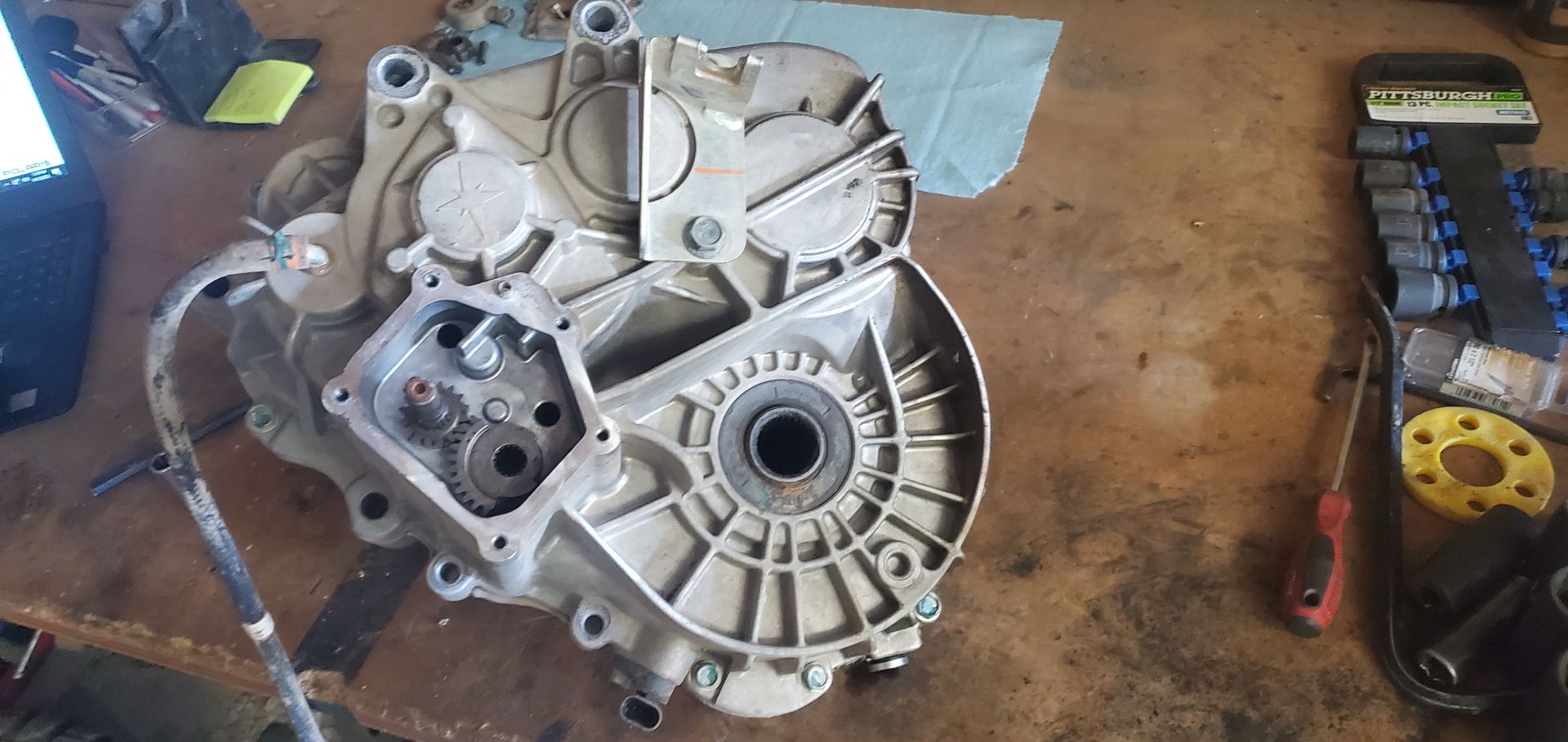 a piece of metal is sitting on top of a wooden table .