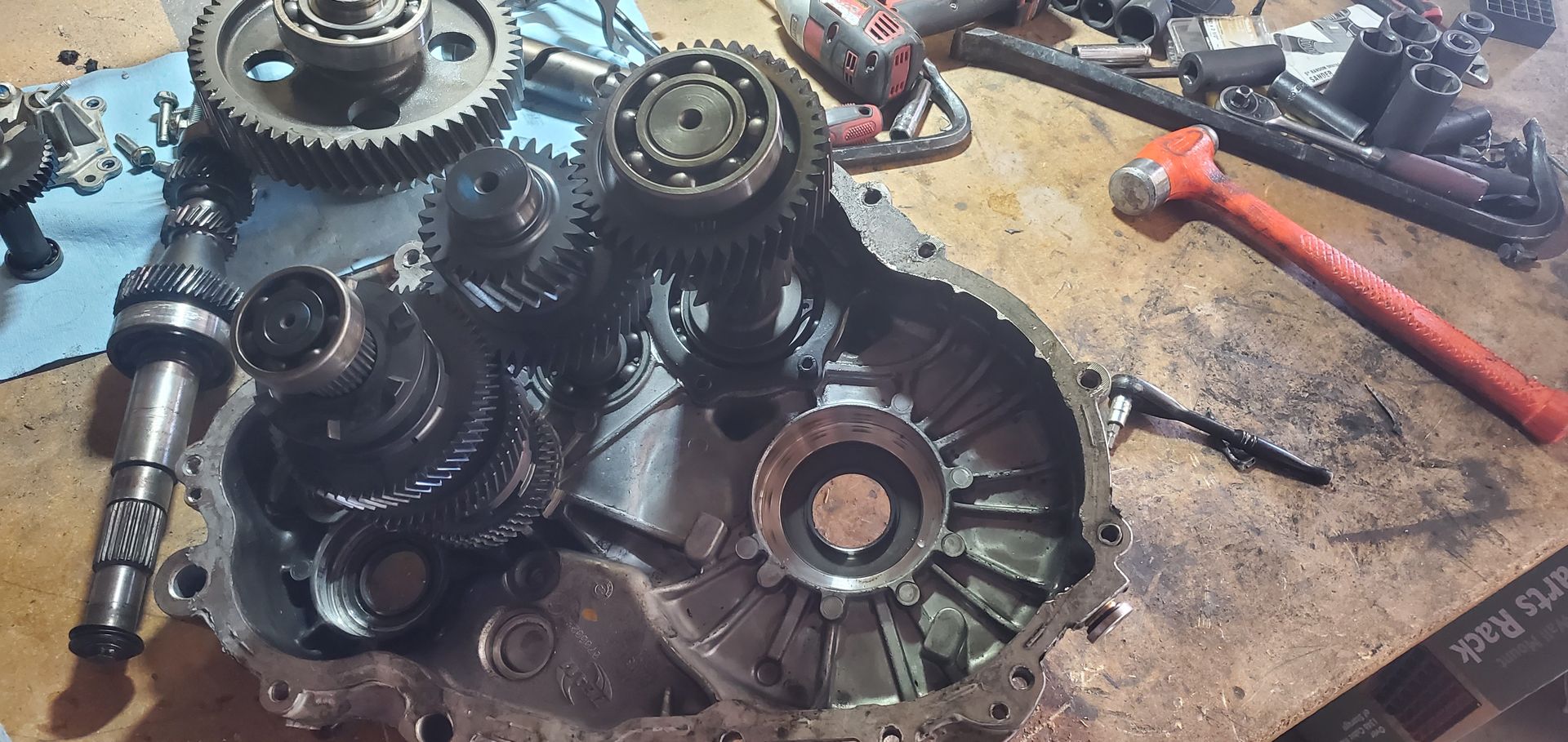 a bunch of gears are sitting on a wooden table .