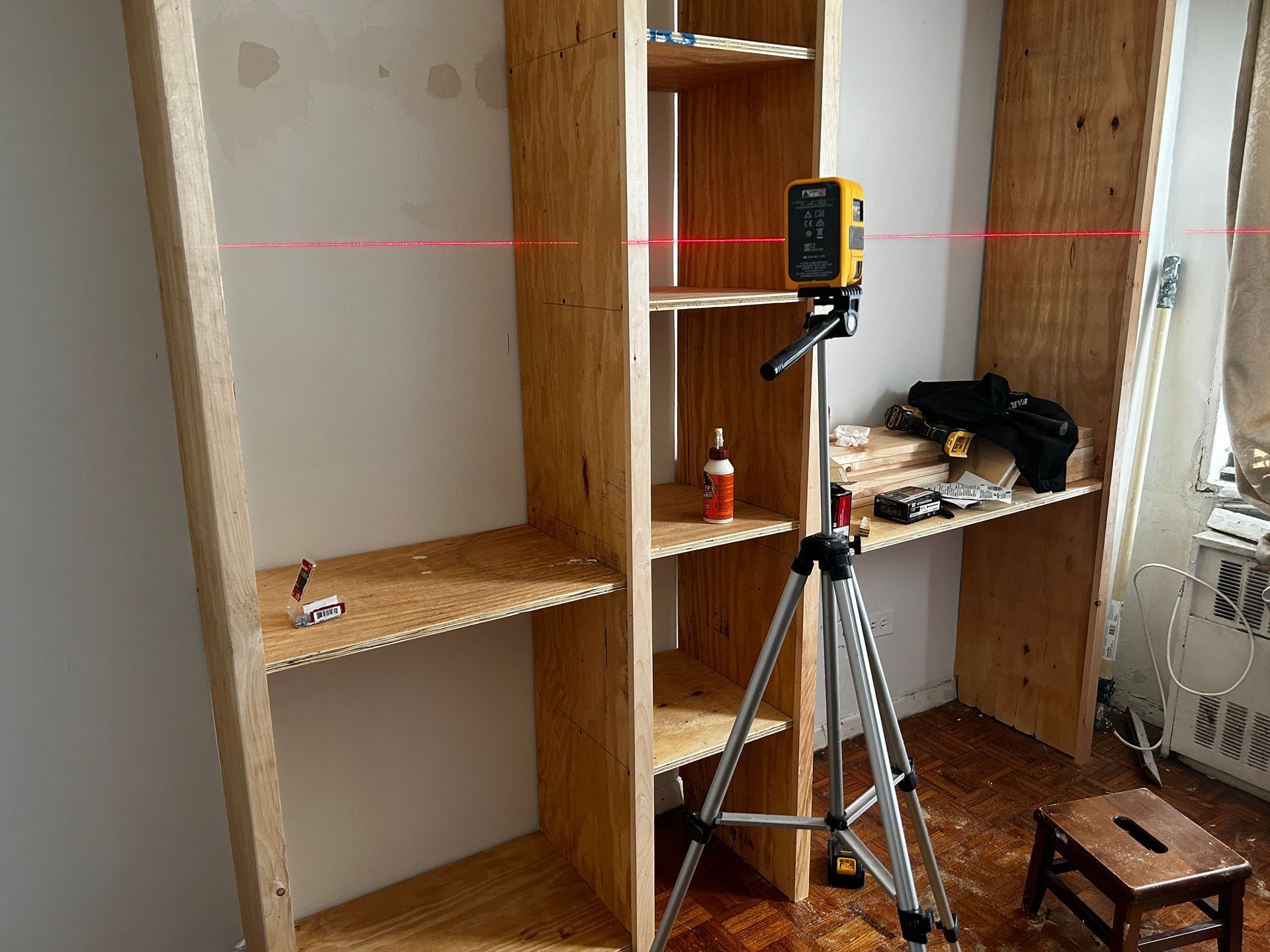 A man is using a drill to drill a hole in a piece of wood.