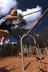 A young child on a swing at Cofrin Park.