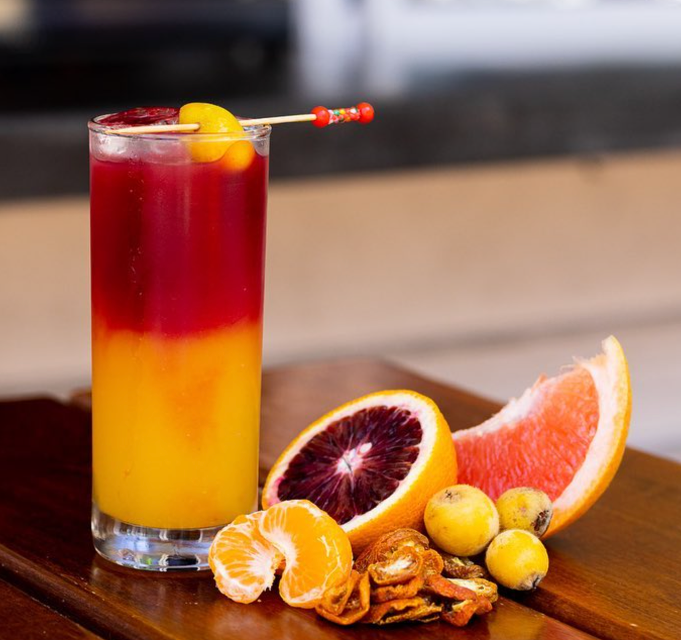 A red and yellow craft cocktail featured at Dragonfly Sushi.