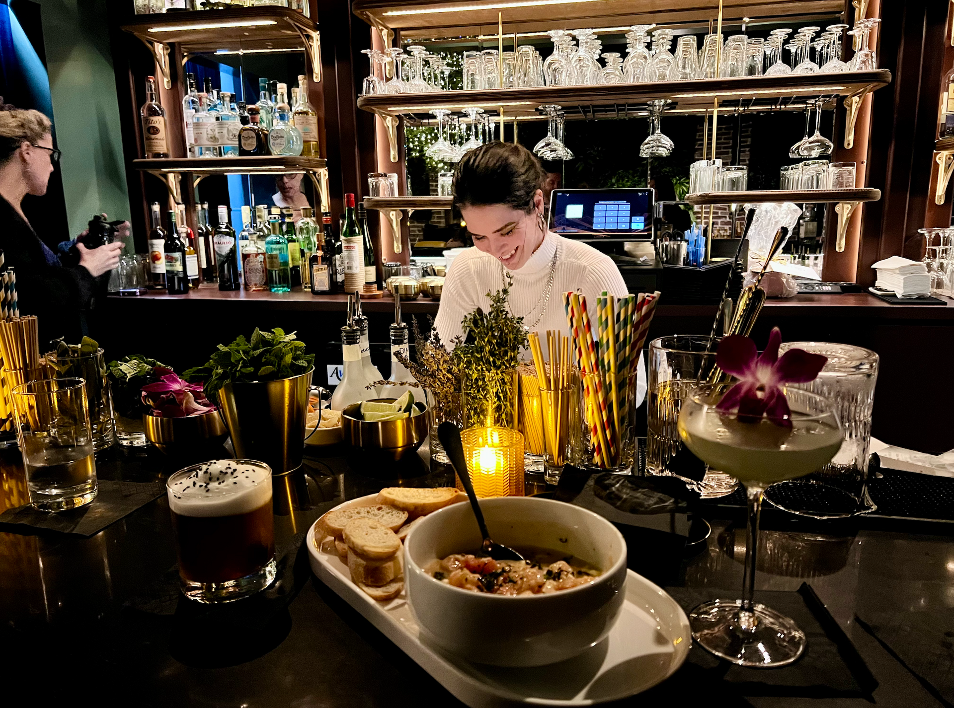 Female bartender preparing drinks at Kin Lounge