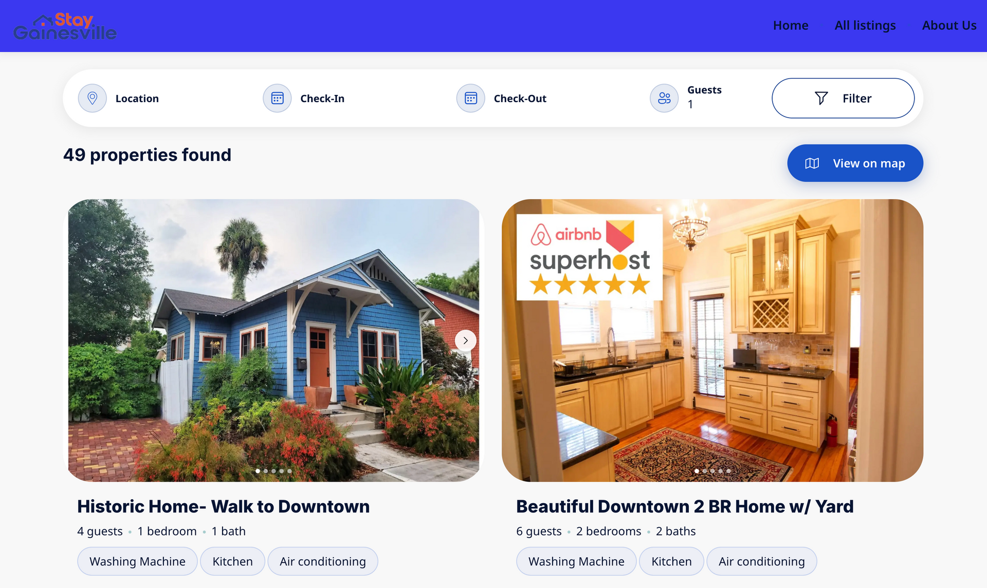 A blue house with a red door and a kitchen on the StayGainesville booking website