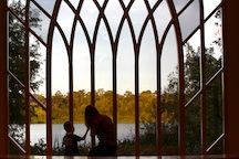 A small child and a female adult sitting at the front of the Baughman Center
