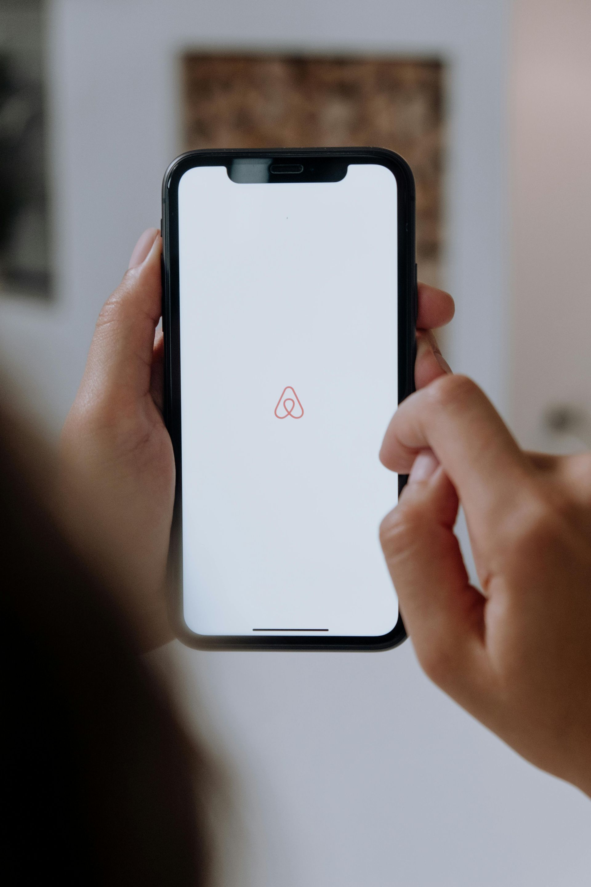 The AirBNB logo on a cell phone
