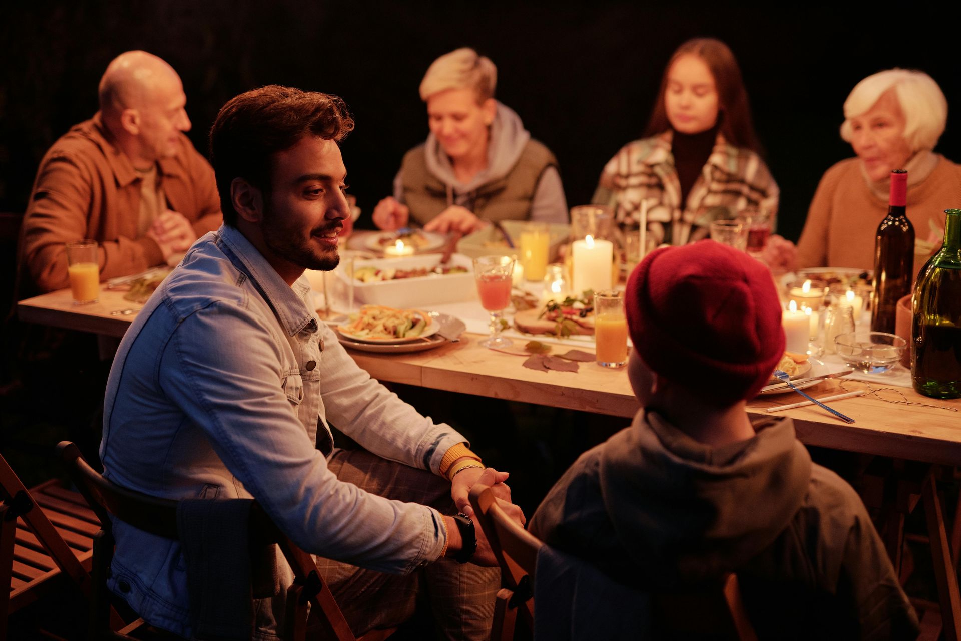 Large group of people around a table. StayGainesville Large Group Homes.