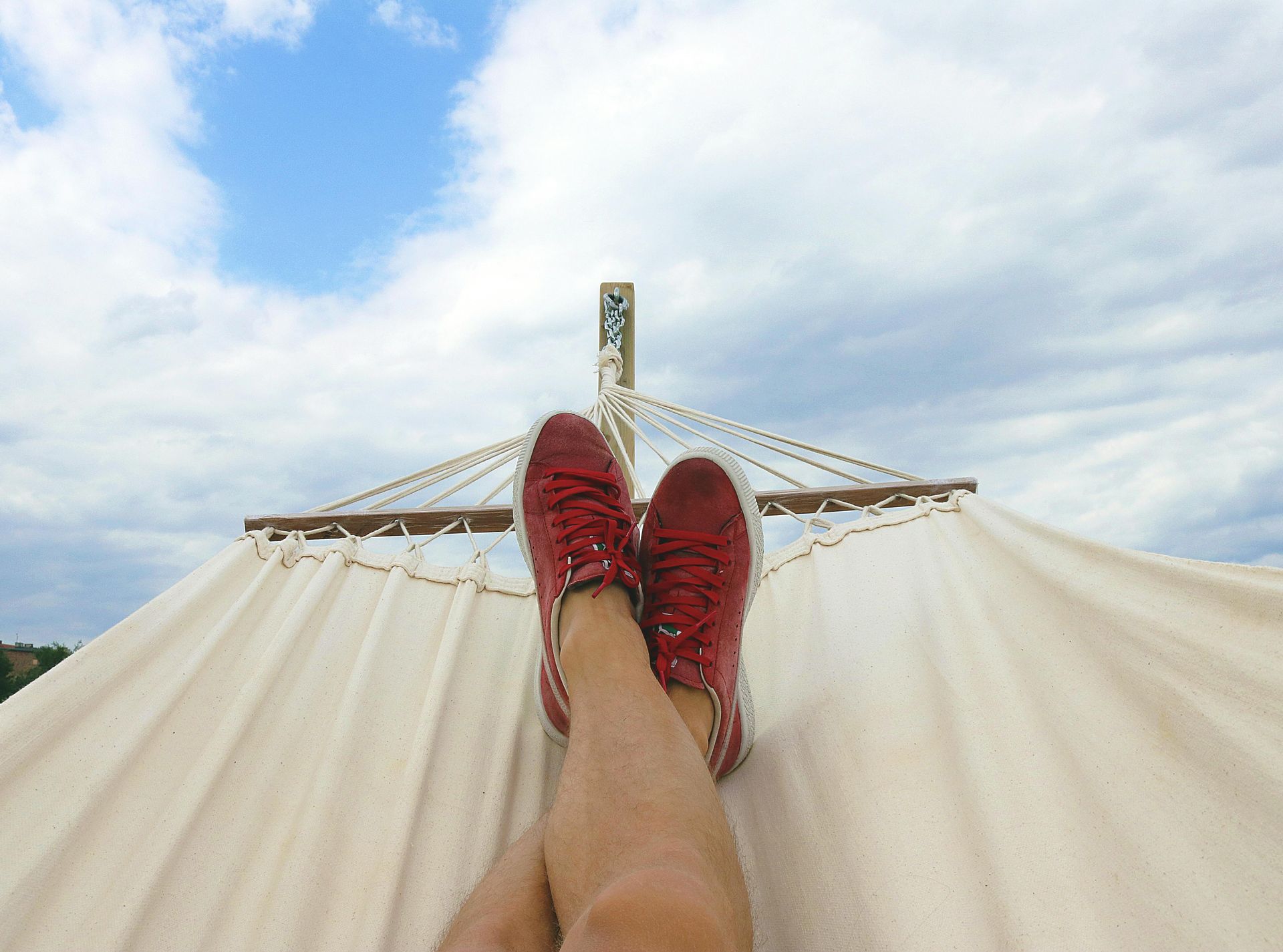 An AirBNB host relaxing on a hammock after turning over property management to StayGainesville
