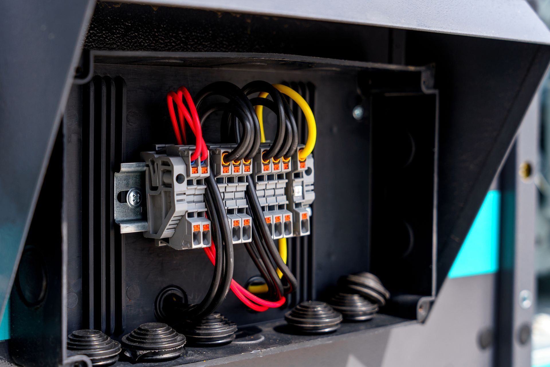 A close up of an electrical box with wires coming out of it.