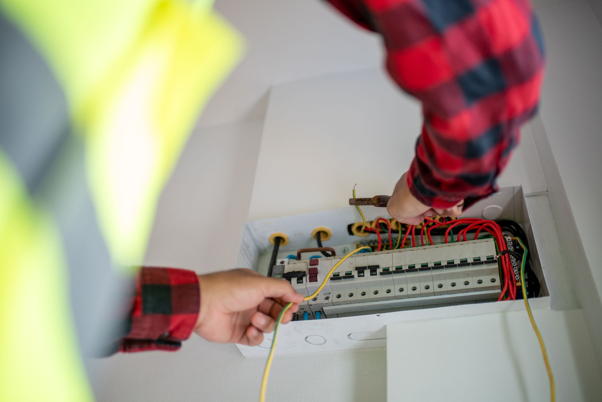 An electrician is working on an electrical box.