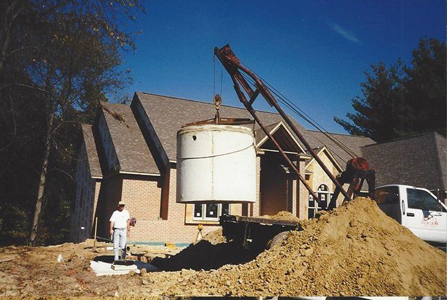 Septic Tank Lowered Into Ground — Plymouth, IN — Creed Septic System Specialist