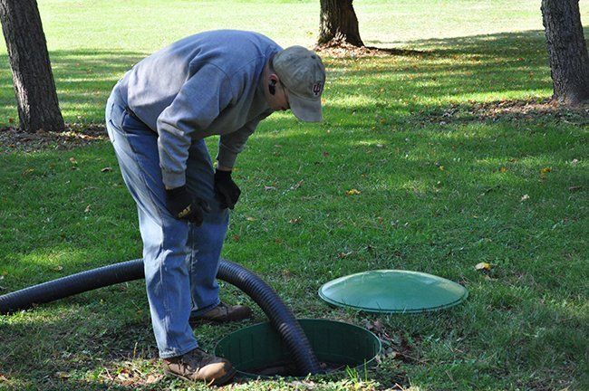 Man Looking at the Sepric Tank — Plymouth, IN — Creed Septic System Specialist