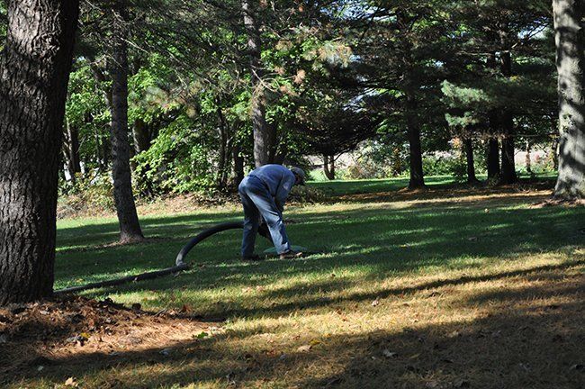 Man Looking at the Cleaning Sepric Tank — Plymouth, IN — Creed Septic System Specialist