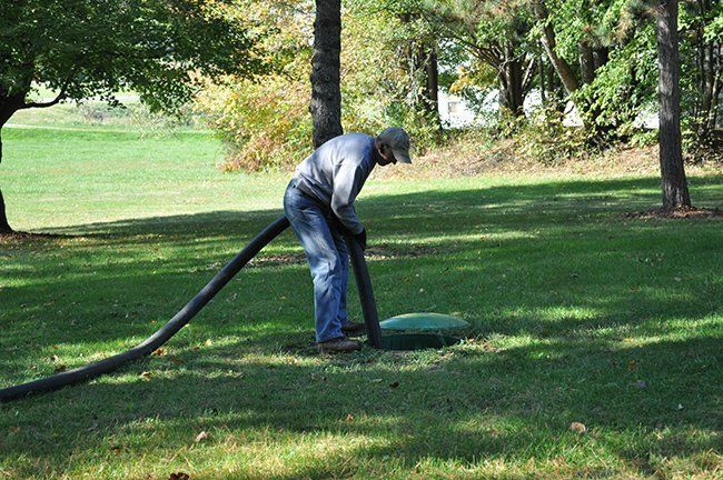 Man Thoroughly Cleaning the Septic Tank — Plymouth, IN — Creed Septic System Specialist