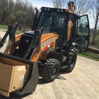 Excavator Truck Lifting a Box — Plymouth, IN — Creed Septic System Specialist