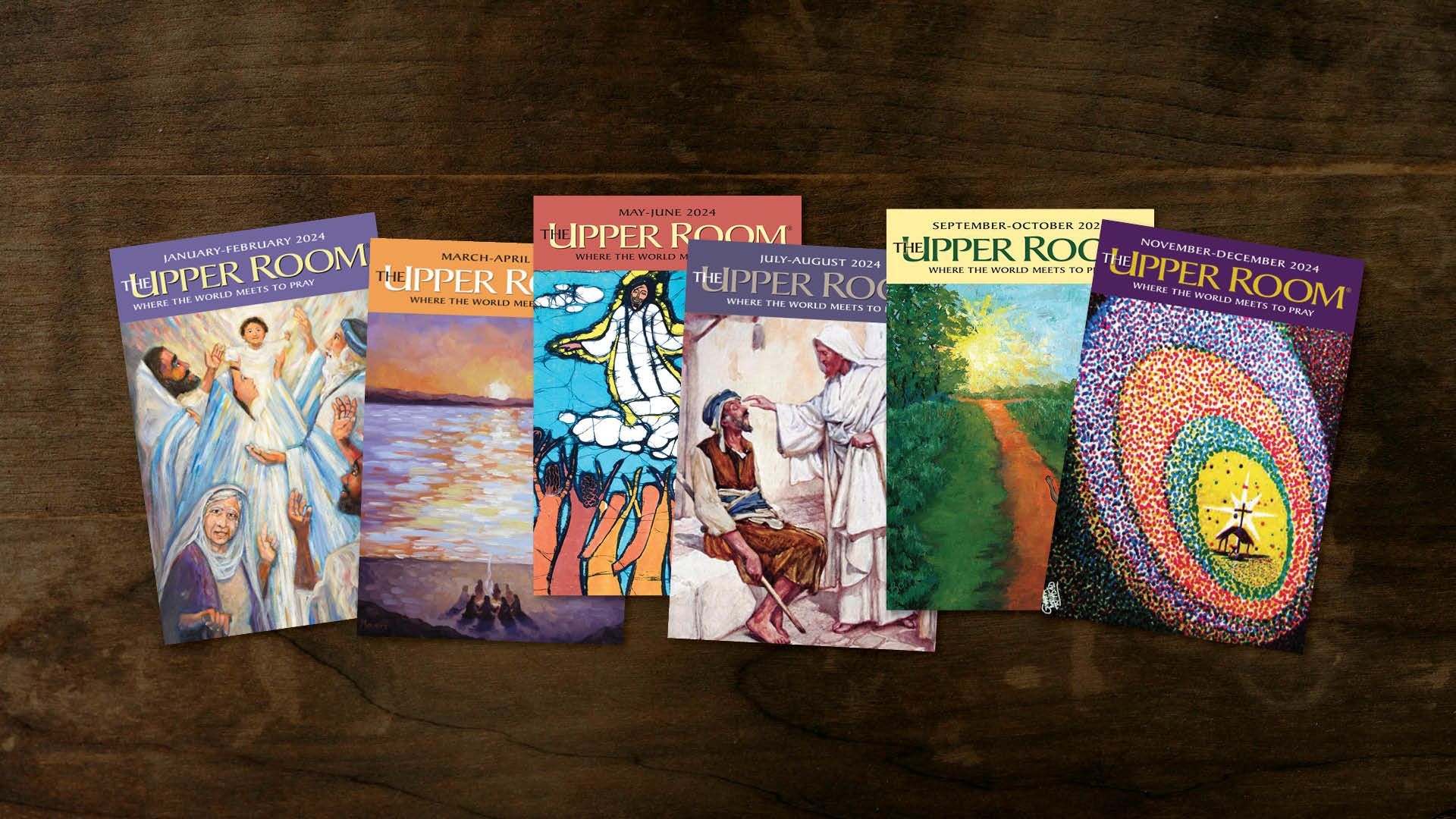 Several books are lined up on a wooden table including one called silver room