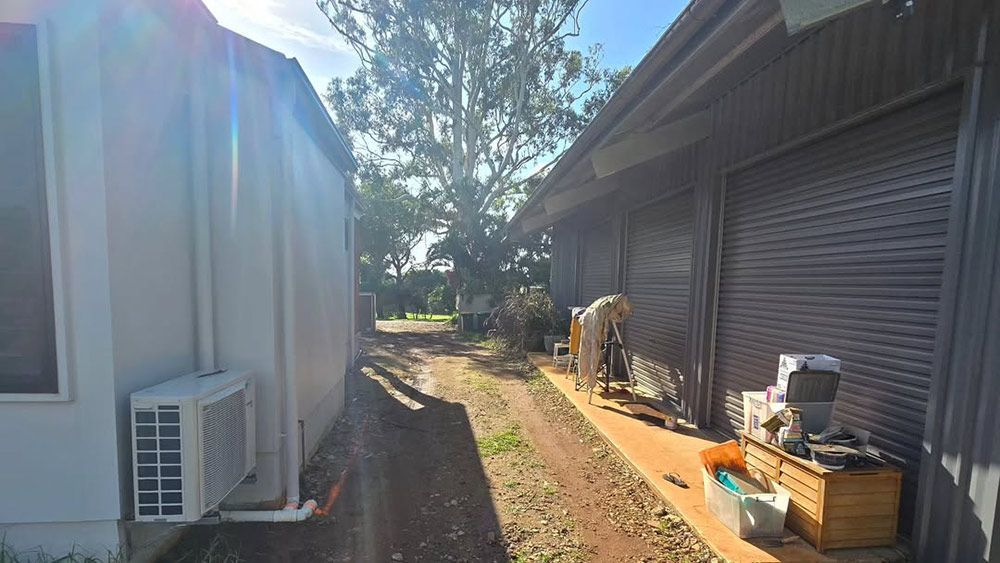 A Row of Houses Sitting Next to Each Other on a Dirt Road — TJ Concreting in Lismore, NSW