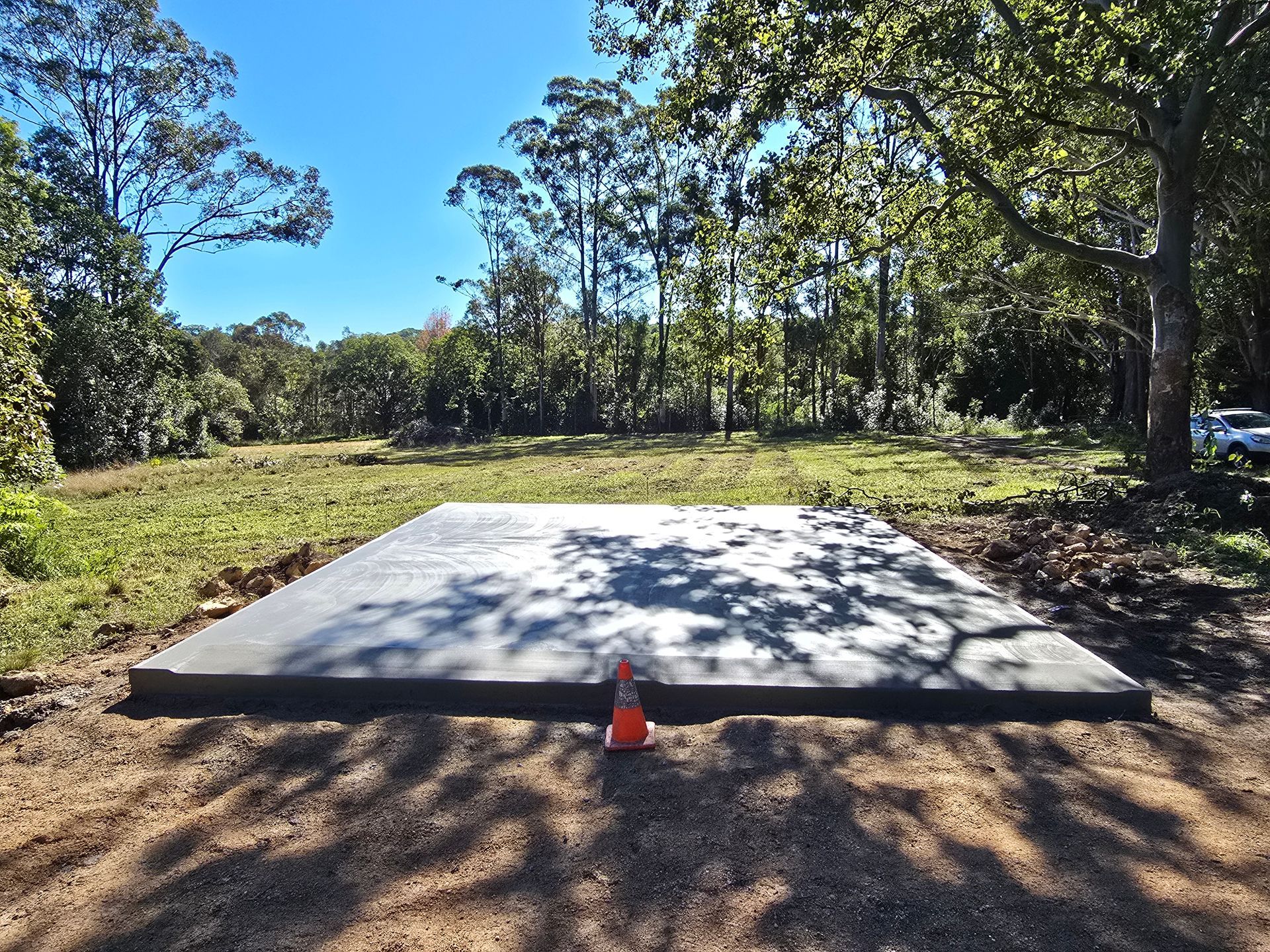 A Concrete Walkway is Being Built in Front of a Brick Building — TJ Concreting in Ballina, NSW