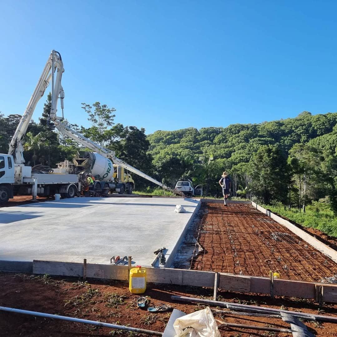 A Concrete Pump is Being Used to Pour Concrete on a Construction Site — TJ Concreting in Federal, NSW 