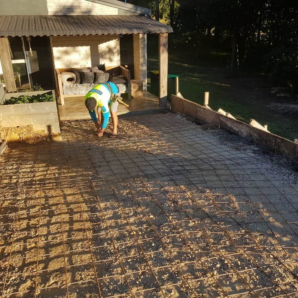 A Man in a Hat is Working on a Concrete Driveway  — TJ Concreting in Mullumbimby, NSW