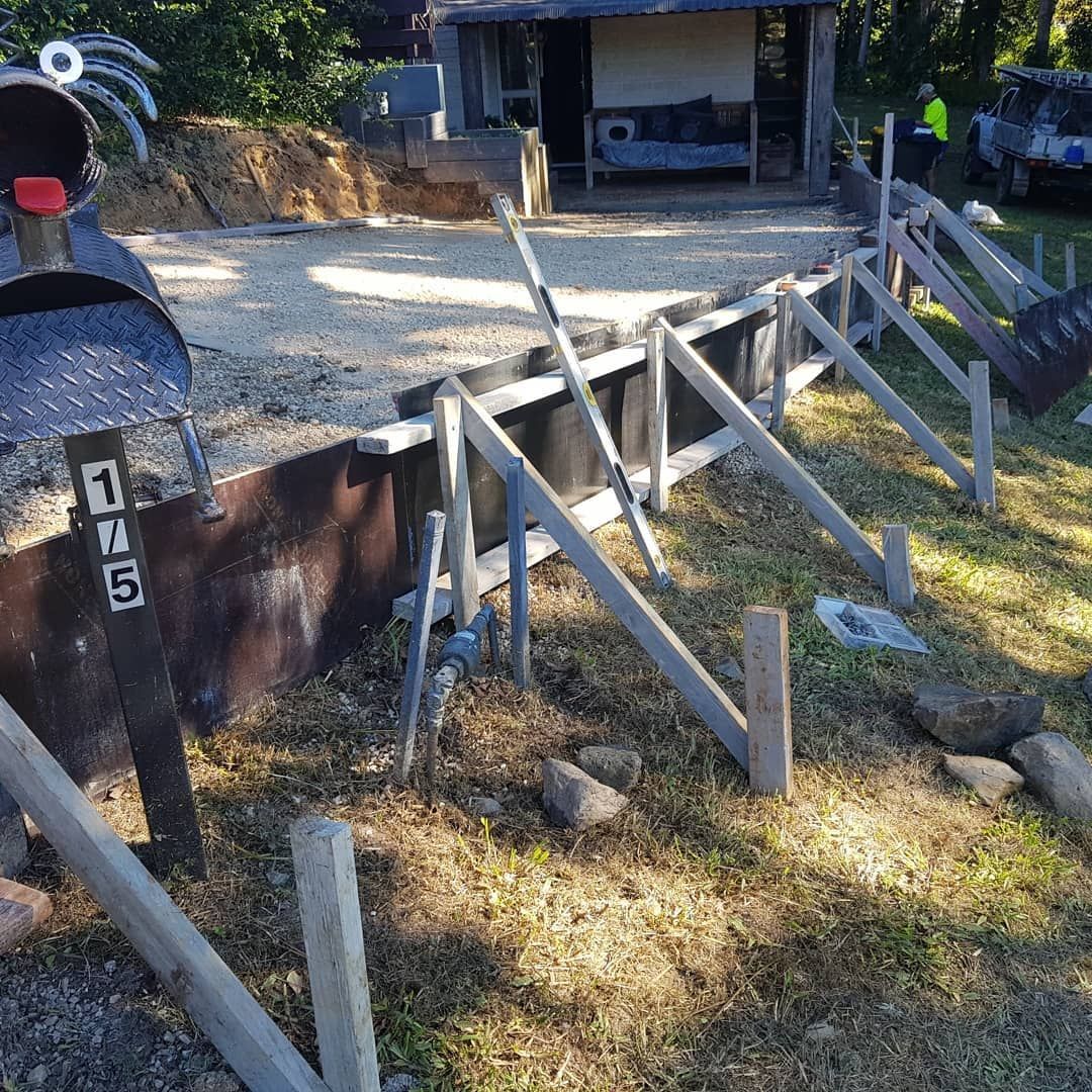 A Construction Site With Wooden Supports for a Foundation — TJ Concreting in Bangalow, NSW