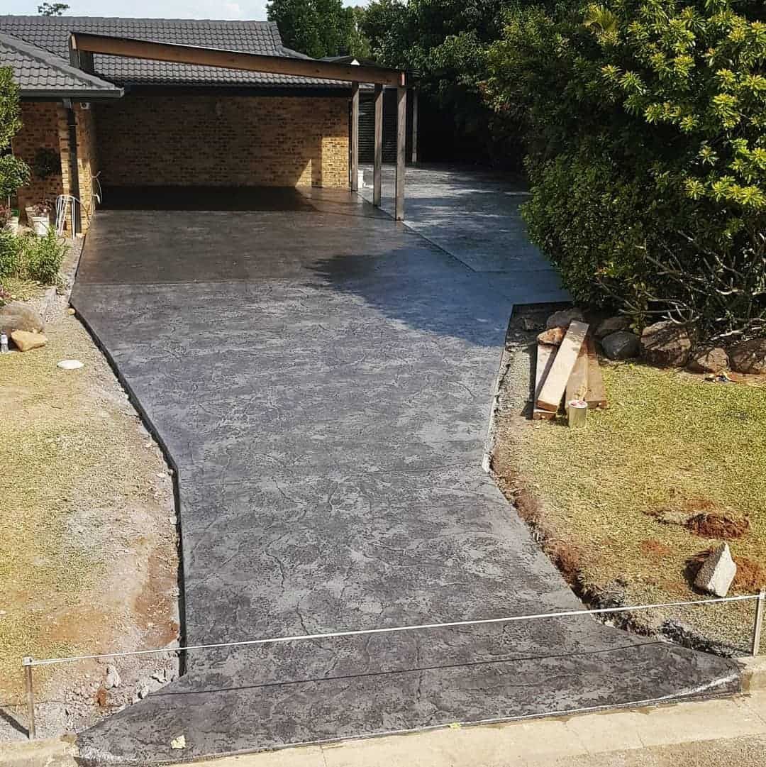 An Aerial View of a Concrete Driveway Leading to a House — TJ Concreting in Federal, NSW 