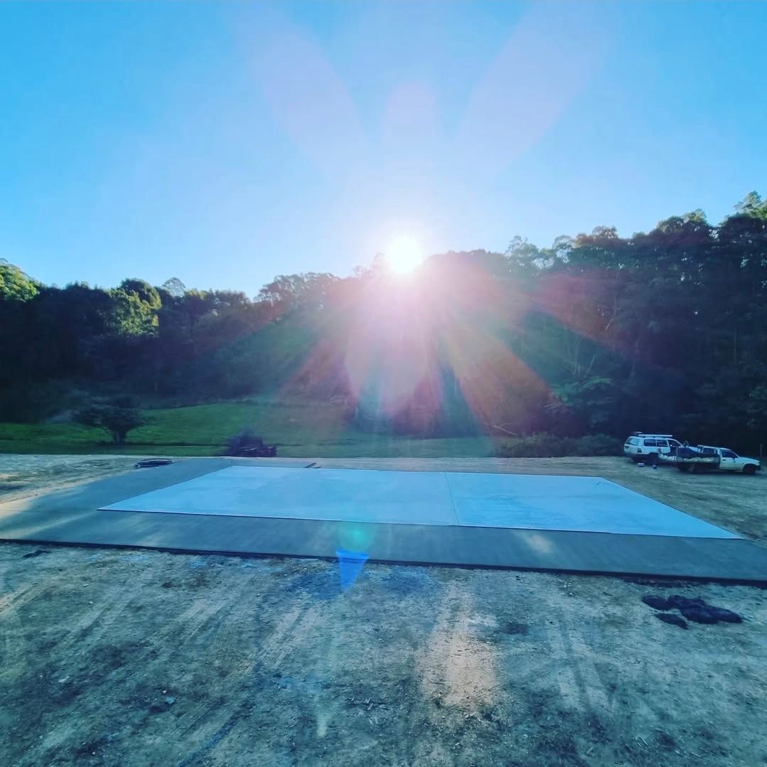 A Man in a Hat is Working on a Concrete Slab — TJ Concreting in Myocum, NSW