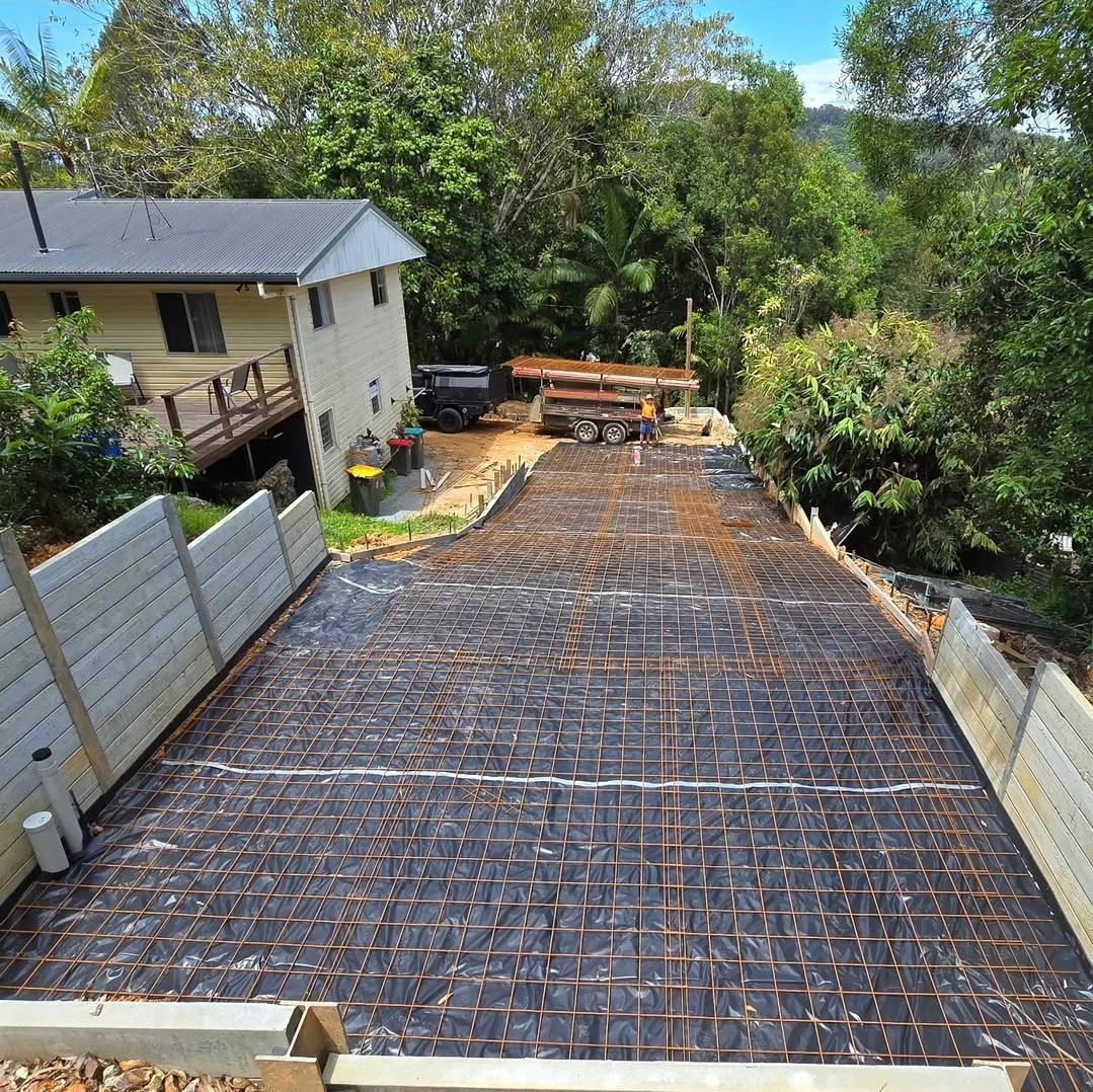A Concrete Driveway Leading to a House — TJ Concreting in Myocum, NSW