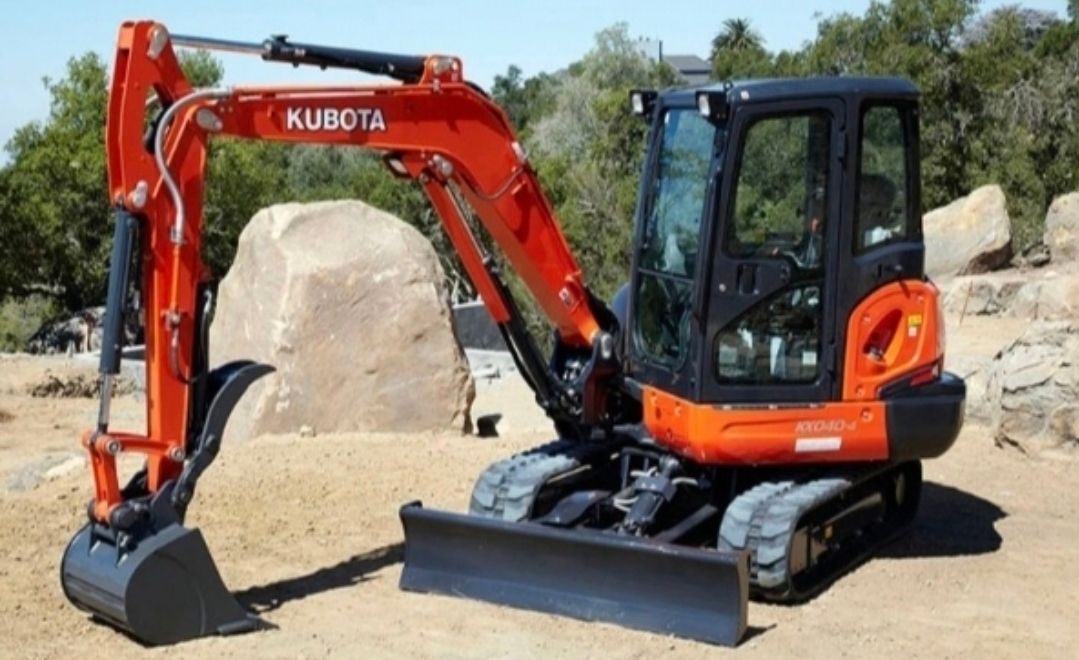 A Concrete Pump Truck is Parked in a Dirt Field With the Sun Shining Through the Trees — TJ Concreting in Bangalow, NSW