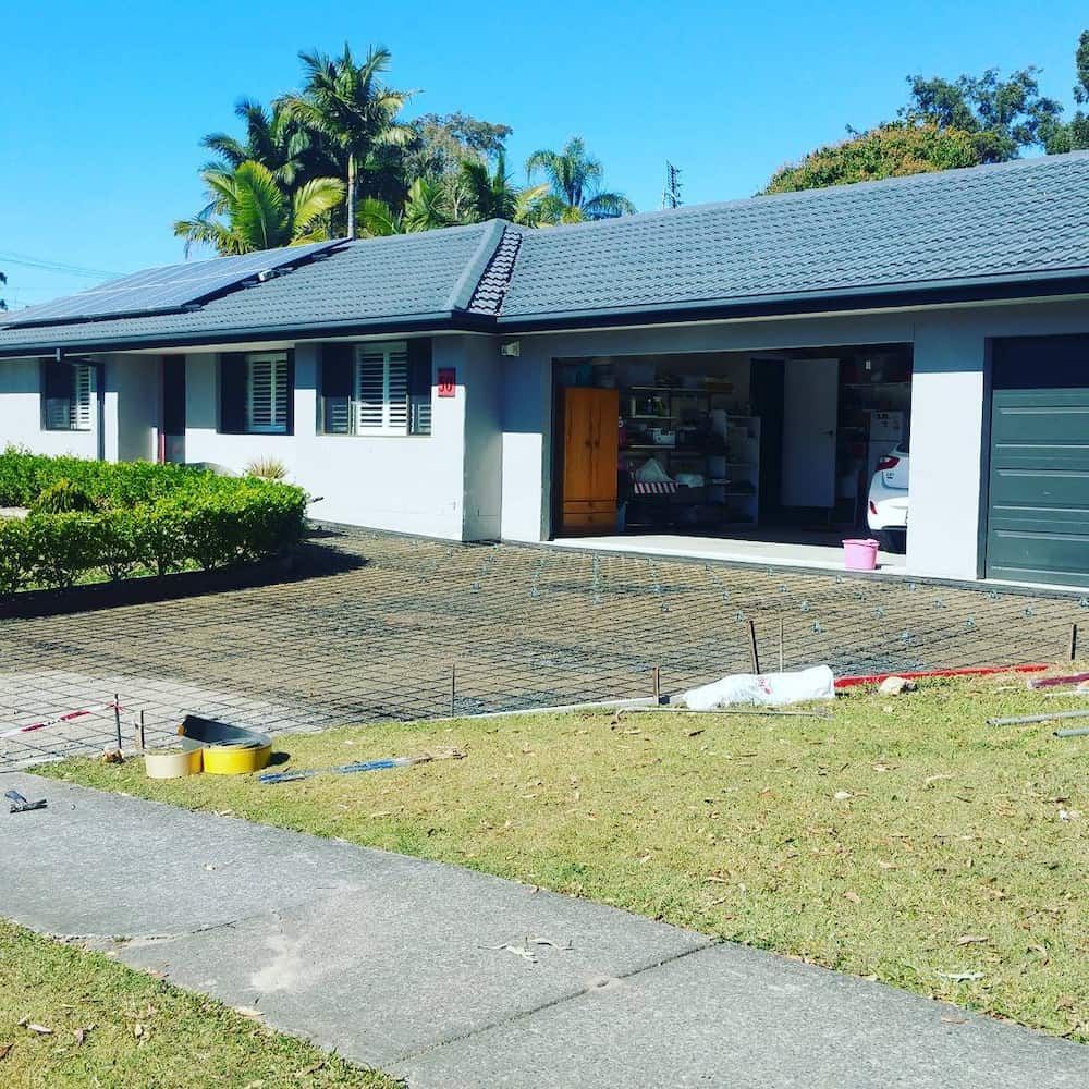 A House With a Car Parked in Front of It — TJ Concreting in Ballina, NSW