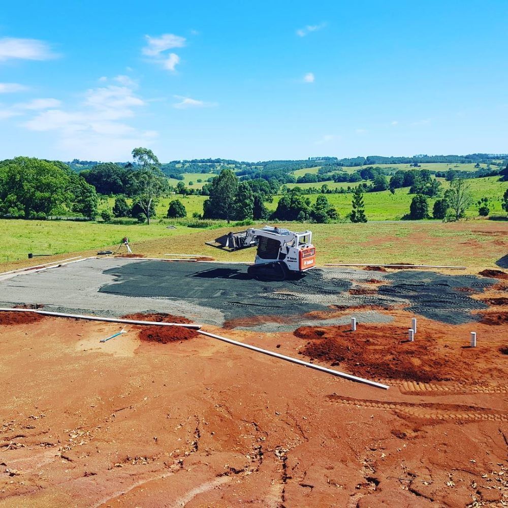 An Aerial View of a Construction Site With a Bulldozer in the Foreground — TJ Concreting in Myocum, NSW