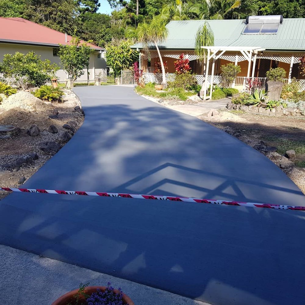 A Driveway is Being Built in Front of a House — TJ Concreting in Murwillumbah, NSW