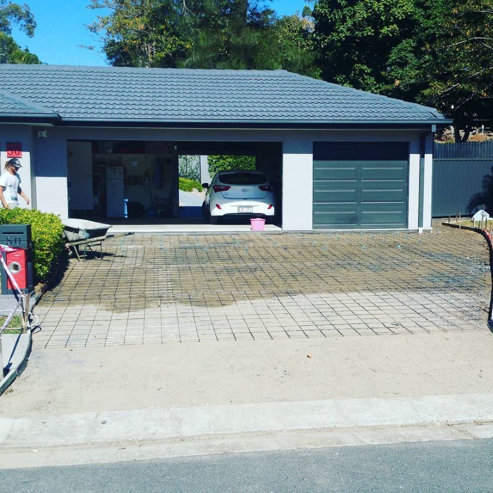 A Car is Parked in the Garage of a House — TJ Concreting in Murwillumbah, NSW