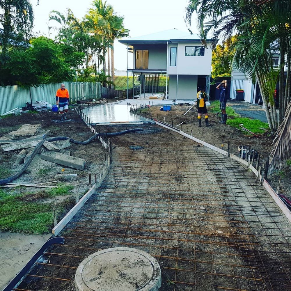 A Concrete Driveway is Being Built in Front of a House — TJ Concreting in Myocum, NSW