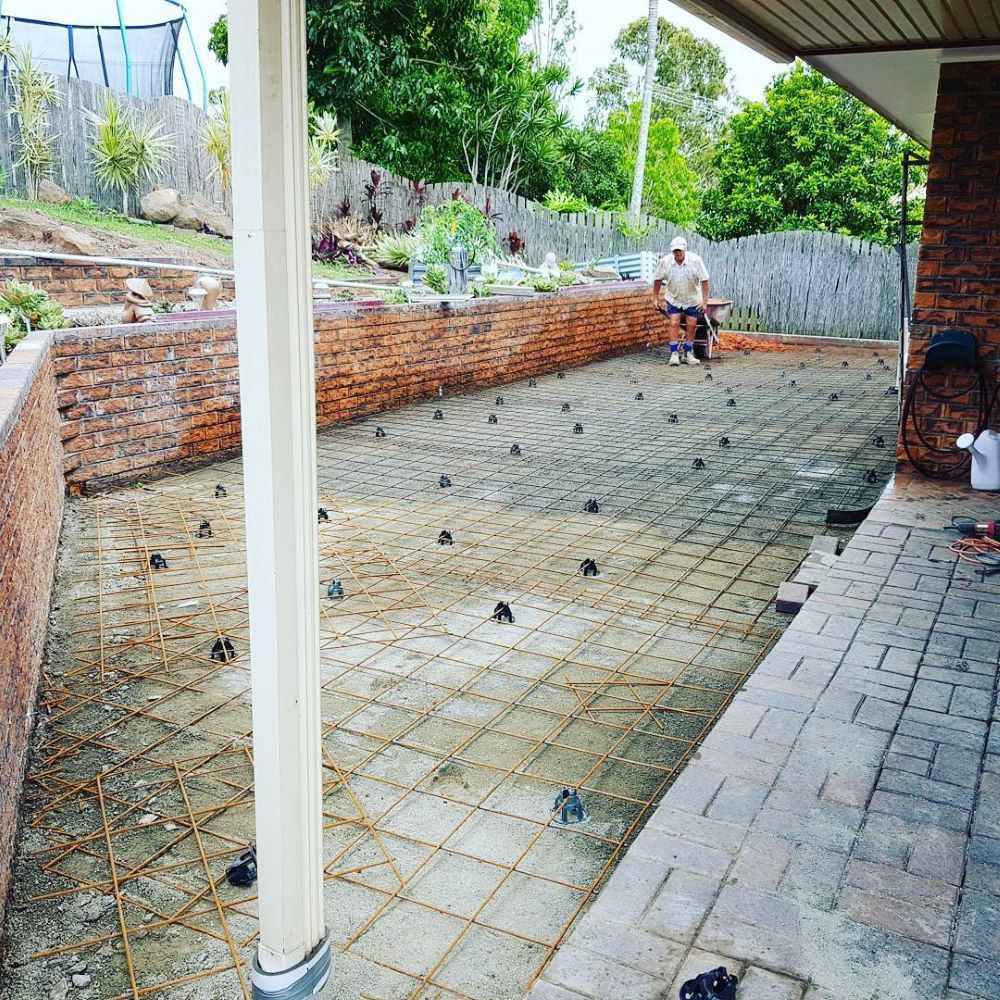 A Person is Working on a Patio Construction Project — TJ Concreting in Myocum, NSW