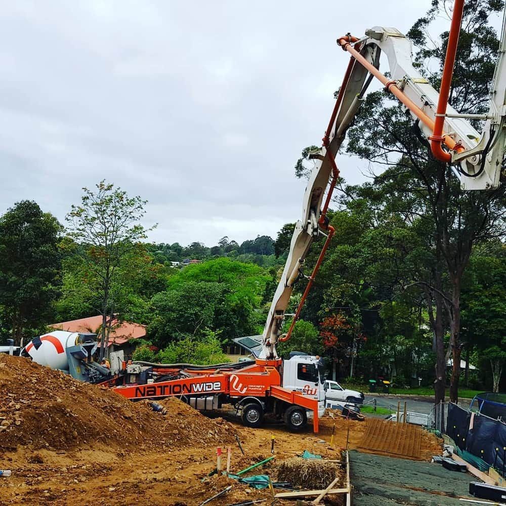 A Concrete Pump is Being Used on a Construction Site — TJ Concreting in Mullumbimby, NSW