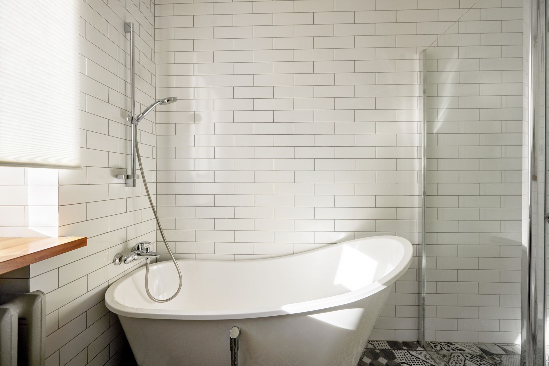 A bathroom with a bathtub and a shower.